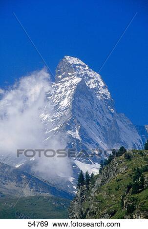 Clouds over snow covered mountain, Mt Matterhorn, Pennine Alps, Italian-Swiss Border View Large Photo Image Stock Photo - Clouds over snow covered mountain, Mt Matterhorn, Pennine Alps, Italian-Swiss Border . Fotosearch