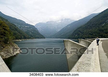 Couple standing on reservoir dam, view of the lake Lago di Vogorno, Tessin Canton, Switzerland, elevated view View Large Photo Image Stock Image - Couple standing on reservoir dam, view of the lake Lago di Vogorno, Tessin Canton, Switzerland, elevated view . Fotosearch
