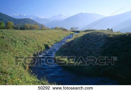 Creek in front of mountains, Vinschgau Valley, Alto Adige, Italy View Large Photo Image Stock Image - Creek in front of mountains, Vinschgau Valley, Alto Adige, Italy . Fotosearch
