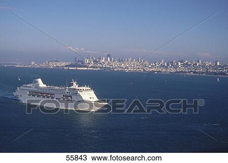 Stock Image - Cruise ship leaving San Francisco Bay with city skyline in background, San Francisco, California, USA . Fotosearch