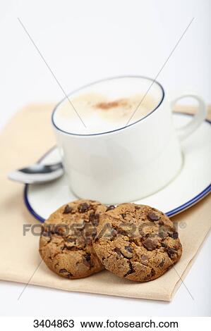 Stock Image - Cup of cappuccino and cookies, close-up . Fotosearch