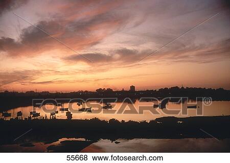 Stock Photo - Fishing boats in river during sunset, San Fernando, Cadiz, Cadiz Province, Andalusia, Spain . Fotosearch