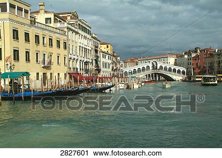 Stock Image - Gondolas at harbor, Grand Canal, Rialto Bridge, Venice, Veneto, Italy . Fotosearch