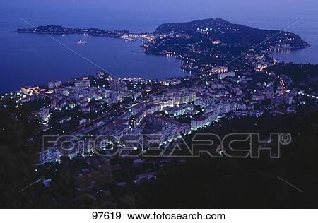 Stock Photo - High angle view of a town lit up at night, Cap Ferrat, Cote d'Azur, France . Fotosearch