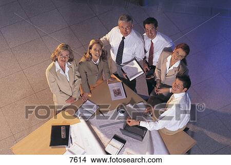 High angle view of group of business people smiling in an office View Large Photo Image Picture - High angle view of group of business people smiling in an office . Fotosearch