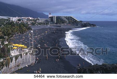 Picture - High angle view of tourists on beach, Puerto Naos, La Palma, Canary Islands, Spain . Fotosearch