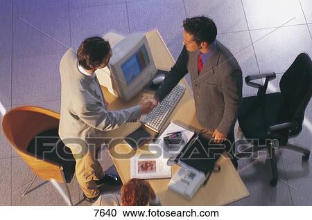 High angle view of two businessmen shaking hands in an office View Large Photo Image Stock Image - High angle view of two businessmen shaking hands in an office . Fotosearch