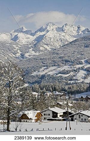 Houses in village with mountain range in background, Niedere Tauern, Ramsau am Dachstein, Liezen, Styria, Austria View Large Photo Image Stock Photo - Houses in village with mountain range in background, Niedere Tauern, Ramsau am Dachstein, Liezen, Styria, Austria . Fotosearch