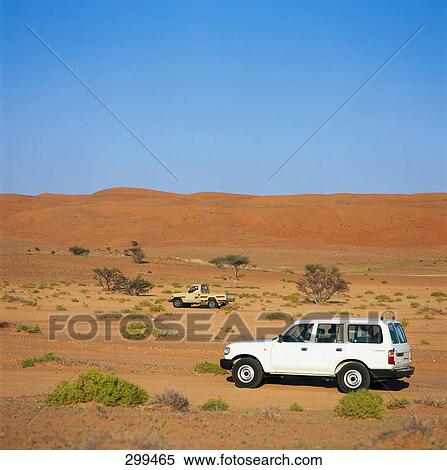 Jeep moving in desert, Al Qabil, Oman View Large Photo Image Stock Photography - Jeep moving in desert, Al Qabil, Oman . Fotosearch