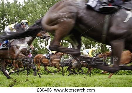 Stock Image - Jockeys riding horses in race . Fotosearch
