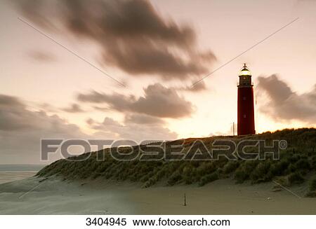Stock Photography - Lighthouse at the beach of Texel at sunrise, Netherlands . Fotosearch