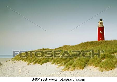 Lighthouse on a dune at the beach of Texel, Netherlands View Large Photo Image Stock Photo - Lighthouse on a dune at the beach of Texel, Netherlands . Fotosearch
