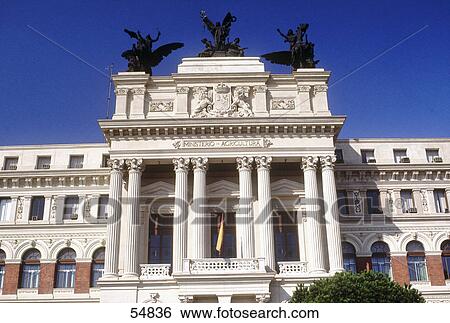 Stock Photograph - Low angle view of statues on wall of ministry of agriculture building, Castille-La Mancha, Spain . Fotosearch
