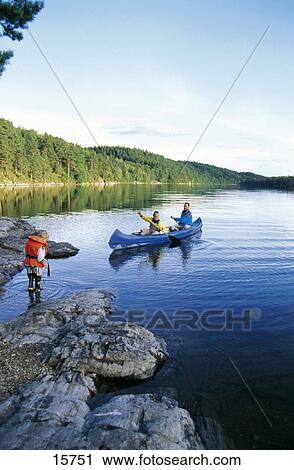 Man rowing canoe in lake with son, lake Ragnerudsjoen, Kroppefjaell, Dalsland, Sweden View Large Photo Image Stock Image - Man rowing canoe in lake with son, lake Ragnerudsjoen, Kroppefjaell, Dalsland, Sweden . Fotosearch