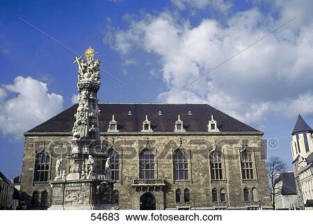 Stock Image - Marian Holy Trinity Column in front of building, Budapest, Hungary . Fotosearch