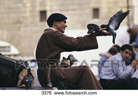 Monk feeding pigeons in front of church, Basilica Of Santa Croce, Florence, Tuscany, Italy View Large Photo Image Stock Photograph - Monk feeding pigeons in front of church, Basilica Of Santa Croce, Florence, Tuscany, Italy . Fotosearch