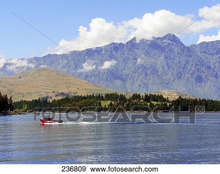 Motorboat in lake, Lake Wakatipu, Queenstown, South Island, New Zealand View Large Photo Image Stock Photo - Motorboat in lake, Lake Wakatipu, Queenstown, South Island, New Zealand . Fotosearch