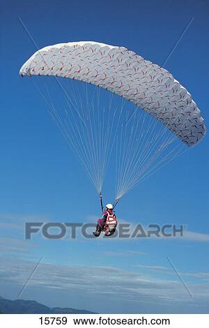 Paraglider with parachute over mountains, Tannheimer Valley, Austria View Large Photo Image Stock Photo - Paraglider with parachute over mountains, Tannheimer Valley, Austria . Fotosearch