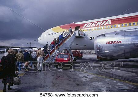 Passengers boarding airplane, Madrid-Barajas Airport, Barajas, Madrid, Spain View Large Photo Image Stock Photo - Passengers boarding airplane, Madrid-Barajas Airport, Barajas, Madrid, Spain . Fotosearch