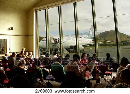 Stock Image - People waiting at airport lounge, Queenstown, South Island New Zealand, New Zealand . Fotosearch