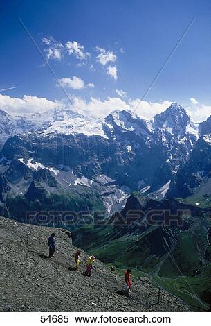 People with mountain range in background, Jungfrau Massif, Muerren, Switzerland View Large Photo Image Stock Photography - People with mountain range in background, Jungfrau Massif, Muerren, Switzerland . Fotosearch
