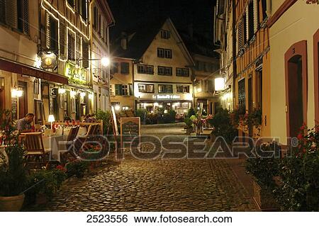 Person sitting in sidewalk cafe at night View Large Photo Image Stock Photograph - Person sitting in sidewalk cafe at night . Fotosearch