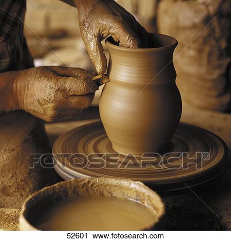 Person's hands moulding clay on pottery wheel View Large Photo Image Stock Image - Person's hands moulding clay on pottery wheel . Fotosearch