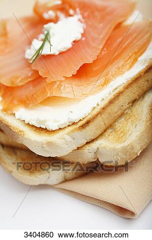Pieces of toast with cream cheese and smoked salmon, close-up View Large Photo Image Stock Image - Pieces of toast with cream cheese and smoked salmon, close-up . Fotosearch