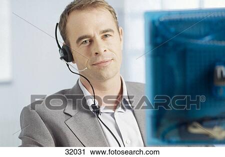 Portrait of a businessman wearing a headset View Large Photo Image Stock Image - Portrait of a businessman wearing a headset . Fotosearch