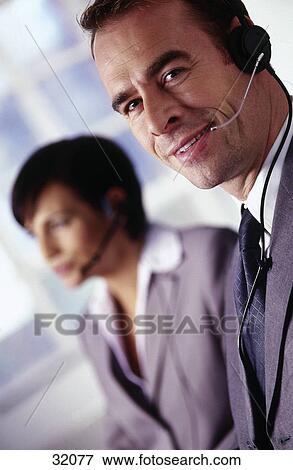 Portrait of a businessman wearing a headset and smiling View Large Photo Image Stock Photo - Portrait of a businessman wearing a headset and smiling . Fotosearch