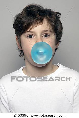 Stock Image - Portrait of boy blowing chewing gum . Fotosearch