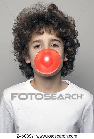 Stock Photo - Portrait of boy blowing chewing gum . Fotosearch
