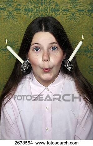 Picture - Portrait of girl with burning candles on her head . Fotosearch