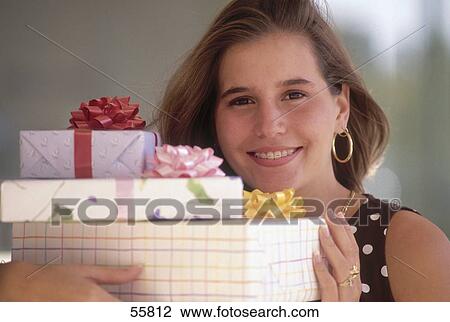 Portrait of young woman smiling with gifts View Large Photo Image Stock Image - Portrait of young woman smiling with gifts . Fotosearch