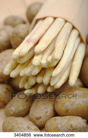 Potatos and a bundle of asparagus, close-up View Large Photo Image Stock Photograph - Potatos and a bundle of asparagus, close-up . Fotosearch