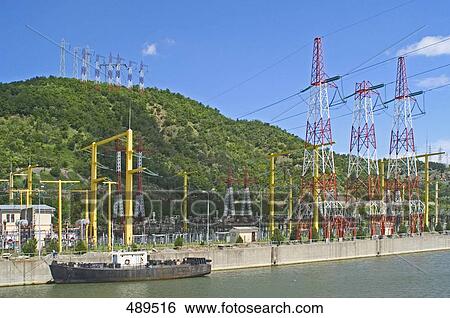 Stock Photograph - Power station at riverbank, Derdap National Park, Danube River, Serbia . Fotosearch