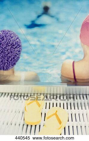 Rear view of two people in swimming pool View Large Photo Image Stock Photography - Rear view of two people in swimming pool . Fotosearch