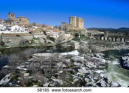 Stock Photography - River flowing through village, Puente del Congosto, Salamanca, Spain . Fotosearch