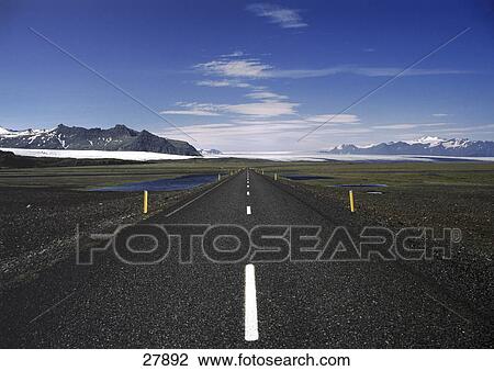 Stock Image - Road passing through landscape, Iceland . Fotosearch