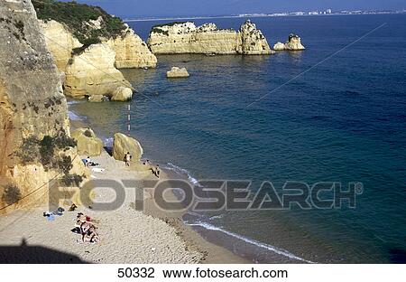Stock Image - Rock formations on beach, Atlantic Ocean, Lagos, Algarve, Portugal . Fotosearch