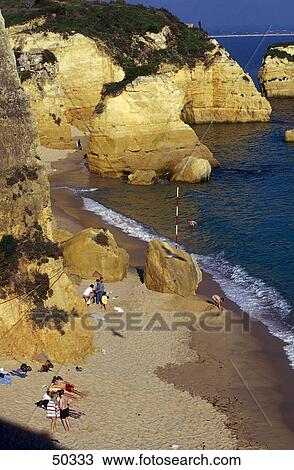 Stock Image - Rock formations on beach, Atlantic Ocean, Lagos, Algarve, Portugal . Fotosearch