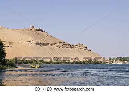Stock Image - Rock grave at the bank of the Nile, Aswan, Egypt . Fotosearch