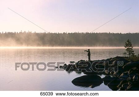 Silhouette of person fishing on lakeside, Hedmark, Norway View Large Photo Image Stock Photo - Silhouette of person fishing on lakeside, Hedmark, Norway . Fotosearch