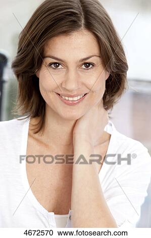 Stock Image - Smiling brunette woman, portrait . Fotosearch