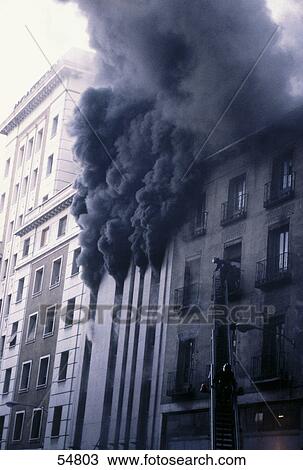 Stock Image - Smoke erupting from burning building, Madrid, Spain . Fotosearch