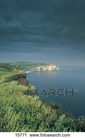 Stock Image - Soorm clouds over cliffs at coast, Etretat, Seine-Maritime, Haute-Normandy, France . Fotosearch