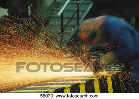 Stock Image - Steel worker welding metal structure, Spain, Europe . Fotosearch