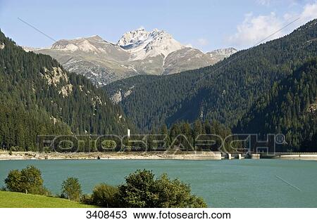 Stock Image - Sufnersee, forest and mountains in the background, Sufers, Switzerland . Fotosearch