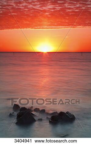 Stock Image - Sunrise over a sea, Texel, Netherlands . Fotosearch