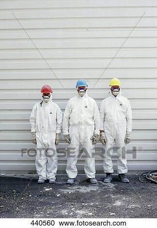 Three man in protective wear standing outside  View Large Photo Image Stock Image - Three man in protective wear standing outside . Fotosearch